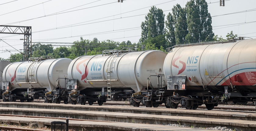 PANCEVO, SERBIA - MAY 19, 2018: Cistern Tank wagons train from Nafta Industria Srbije passing in an industrial district of Pancevo. NIS is a Serbian multinational oil and gas companyPicture of Oil Wagons (tankers) from the Serbian branch of Gazprom, NIS, passing near a factory in an industrial environment of Pancevo, Serbia. Naftna Industrija Srbije, or NIS, is a Serbian multinational oil and gas company
