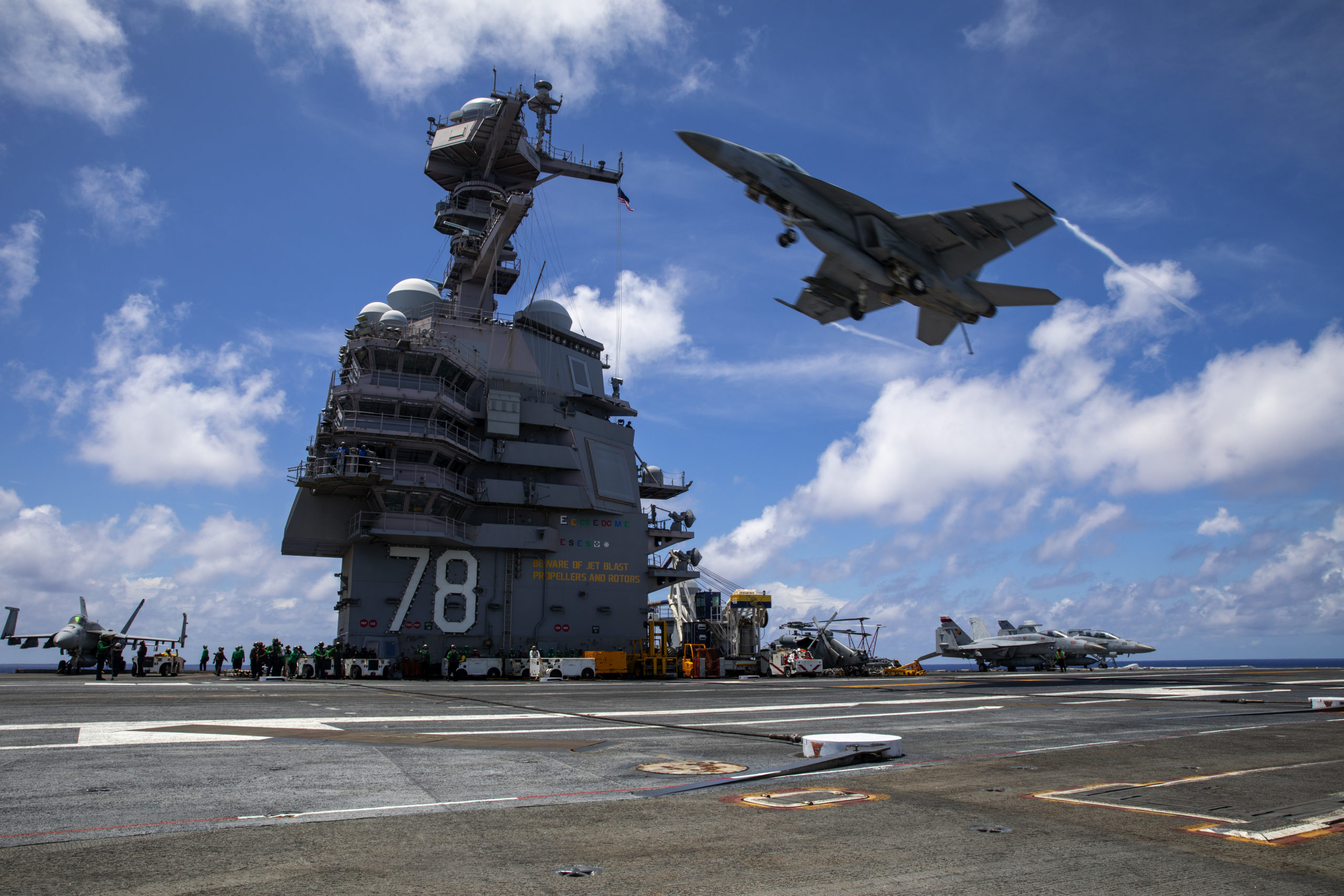A Carrier Air Wing 8 F/A-18E Super Hornet, assigned to Strike Fighter Squadron 37, passes over the flight deck of the world’s largest aircraft carrier, USS Gerald R. Ford (CVN 78), July 6, 2025. Gerald R. Ford, a first-in-class nuclear aircraft carrier and deployed flagship of Carrier Strike Group Twelve, incorporates modern technology, innovative shipbuilding designs, and best practices from legacy aircraft carriers to increase the U.S. Navy’s capacity to underpin American security and economic prosperity, deter adversaries, and project power on a global scale through sustained operations at sea. (U.S. Navy photo by Mass Communication Specialist Seaman Jarrod Bury)