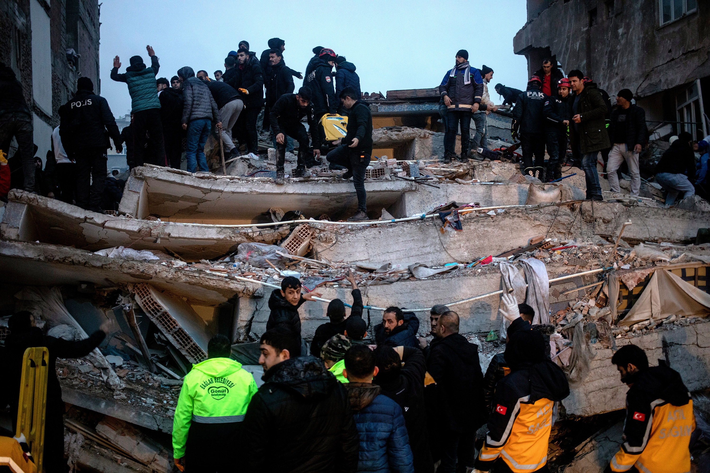 Mandatory Credit: Photo by REFIK TEKIN/EPA-EFE/Shutterstock (13755723f)Turkish emergency personnel and others try to help victims at the site of a collapsed building after an earthquake in Diyarbakir, Turkey 06 February 2023. According to the US Geological Service, an earthquake with a preliminary magnitude of 7.8 struck southeast Turkey close to the Syrian border. The earthquake caused buildings to collapse and sent shockwaves over northwest Syria, Cyprus, and Lebanon.Earthquake in southeast Turkey, Diyarbakir - 06 Feb 2023