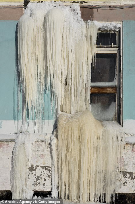 39895050-9311741-Icicles_are_pictured_on_the_window_of_an_abandoned_building_The_-m-76_1614596988838.jpg